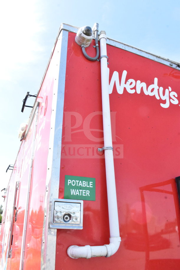 2022 Rock Solid Cargo 8.5x28 Wendy's Food Trailer with signage. Features potable water access and exterior pipes.