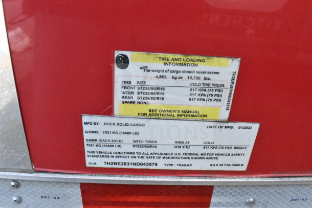 Close-up of a 2022 Rock Solid Cargo trailer label. Shows tire and loading info, GVWR, VIN 7H2BE2831ND043576, manufactured 01/2022.
