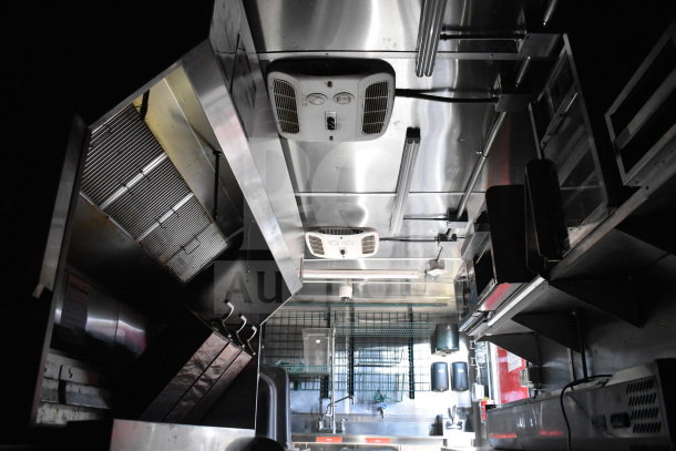 Titanium Cargo Trailers 8.5'x28' Wendy's Food Trailer interior featuring CaptiveAire grease hood, stainless steel surfaces, and storage racks.