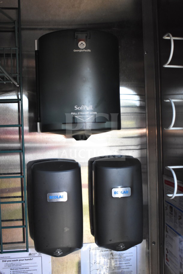 Georgia-Pacific SofPull paper towel dispenser and two Ecolab soap dispensers mounted on stainless steel wall.