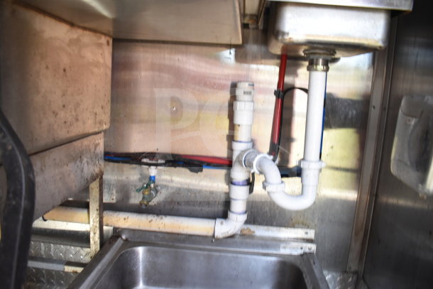 Titanium Cargo Trailers 8.5'x28' Wendy's food trailer interior, showing plumbing and under-sink piping. Used condition.