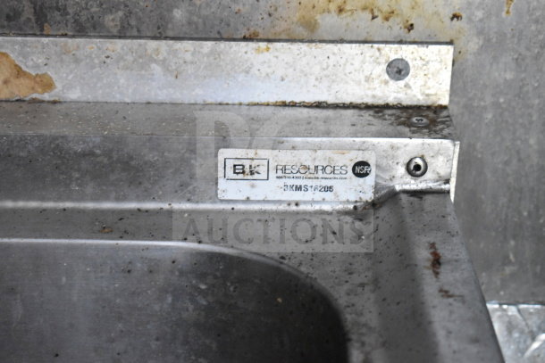 Titanium Cargo Trailers food trailer with BK Resources label BKMS1205, showing wear and rust, featuring kitchen equipment.