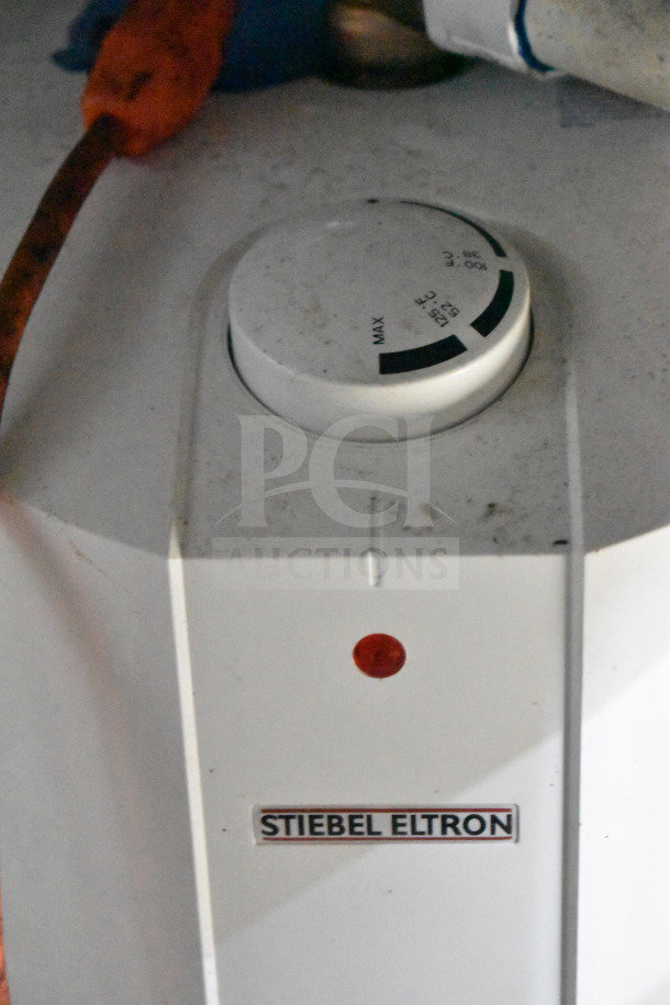 A Stiebel Eltron water heater dial, labeled with temperature settings, featuring a red indicator light on a white panel.
