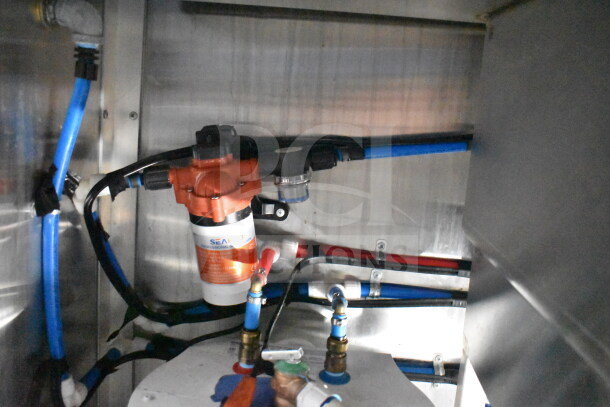 Titanium Cargo Trailers 8.5'x28' food trailer interior showing plumbing and Seaflo pump connections.