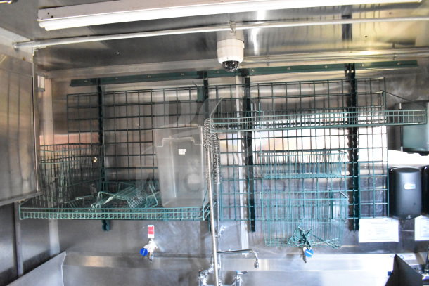 Titanium Cargo Trailers 8.5'x28' Wendy's Food Trailer interior showing storage racks and stainless steel fixtures.