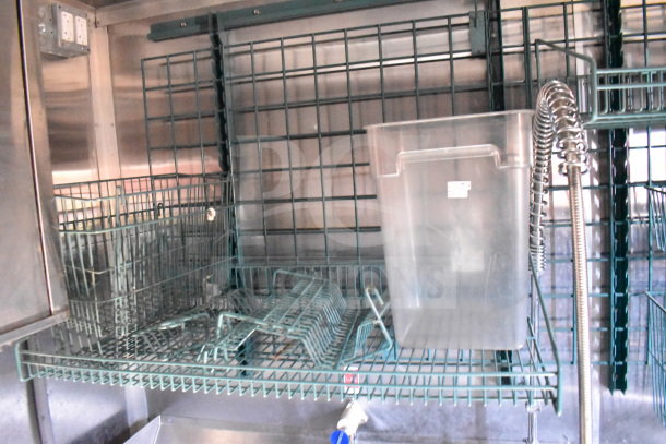 Metal shelving inside Titanium Cargo Trailers 8.5'x28' Wendy's food trailer with storage baskets and a clear container.