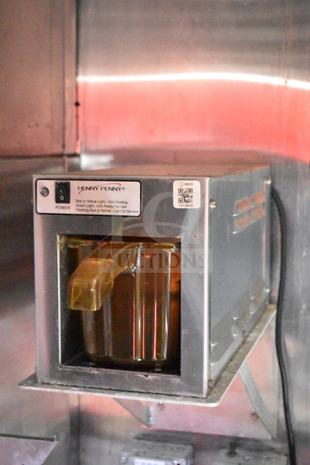 Henny Penny fryer inside Titanium Cargo 8.5'x28' food trailer, showcasing stainless steel design and condition. Power label visible.