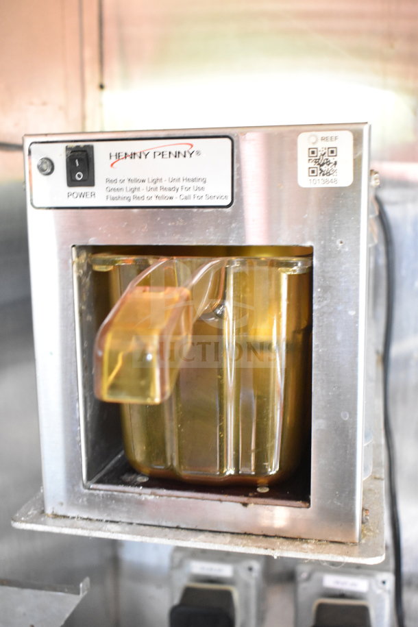 Henny Penny fryer inside Titanium Cargo 8.5'x28' food trailer, with power switch and status lights.