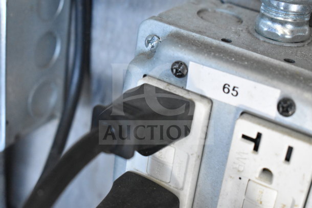 Electrical outlet inside Titanium Cargo Trailers 8.5'x28' Wendy's Food Trailer, labeled with number 65.