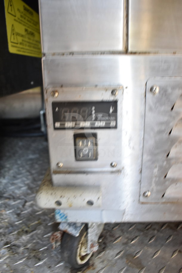 Titanium Cargo Trailers 8.5'x28' food trailer equipment. Visible: digital control panel, metal casing, and caster wheel.