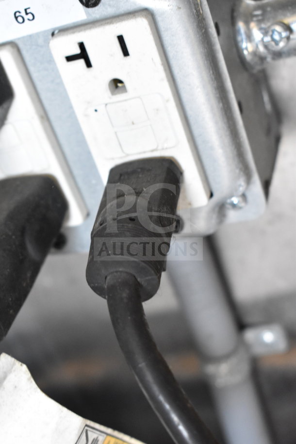 Electrical outlet and plug connection inside Titanium Cargo Trailers 8.5'x28' Wendy's Food Trailer, showing durable wiring setup.