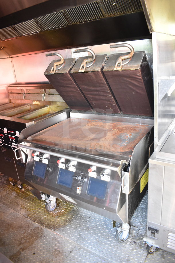 Titanium Cargo Trailers 8.5'x28' food trailer interior with griddle, CaptiveAire grease hood, and Henny Penny fryer.