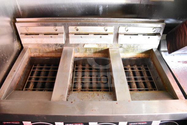 Henny Penny fryer with three compartments in used condition inside Wendy's food trailer.
