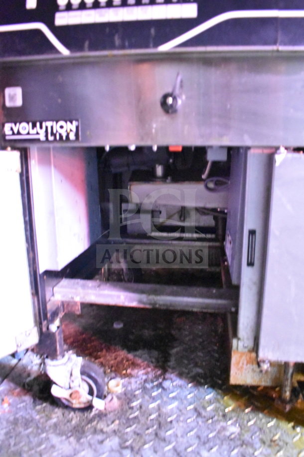 Titanium Cargo Trailers 8.5'x28' food trailer interior, features CaptiveAire grease hood, visible wear on flooring.