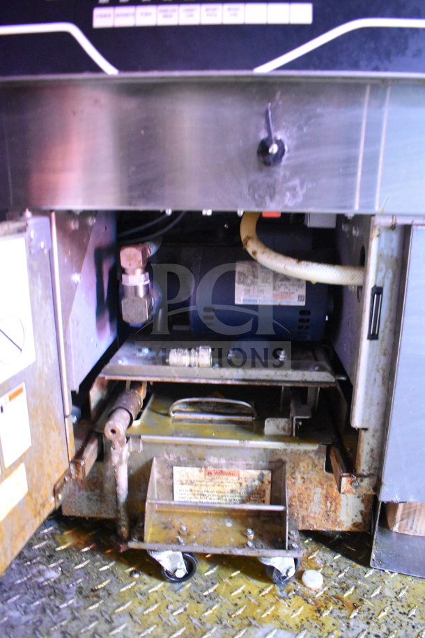 Titanium Cargo Trailers Wendy's food trailer underbody. Visible equipment components and metal casters. Condition shows wear.