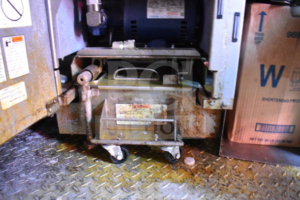 Interior view of Titanium Cargo Trailers 8.5'x28' food trailer showing equipment base with visible rust and warning labels.