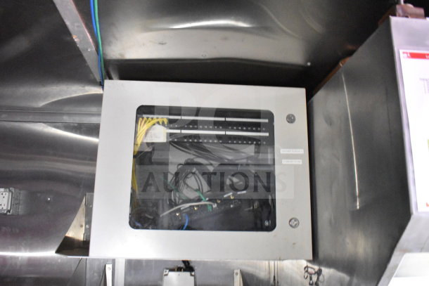 Control cabinet inside Titanium Cargo Trailers 8.5'x28' food trailer. Contains wiring and ports, part of electrical system.