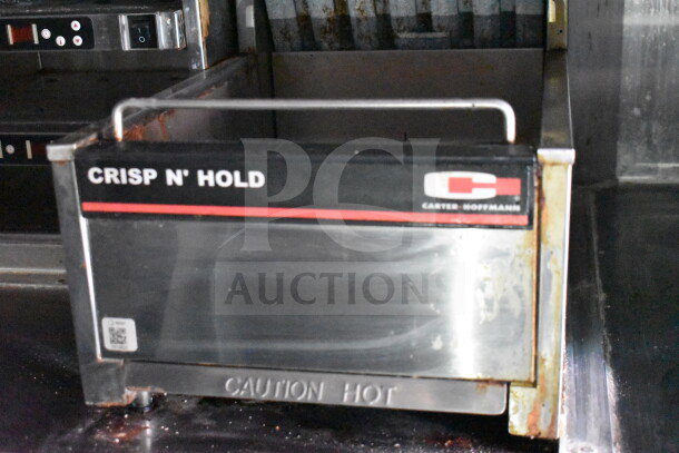 Carter Hoffmann Crisp N' Hold warmer in used condition inside 8.5'x28' Wendy's food trailer. Marked "Caution Hot."