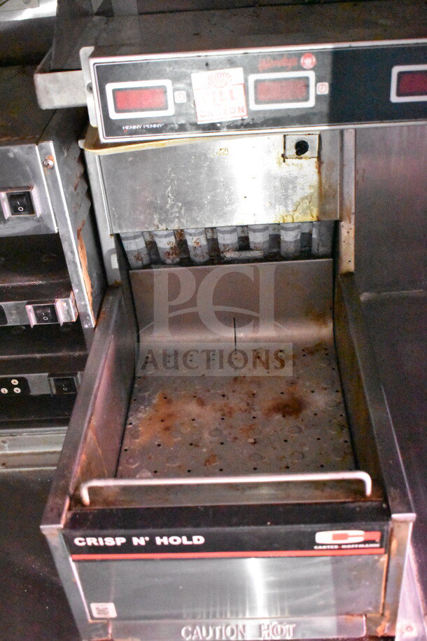 Henny Penny Crisp N' Hold food warmer, showing signs of use, featuring control panel and "Caution Hot" marking.