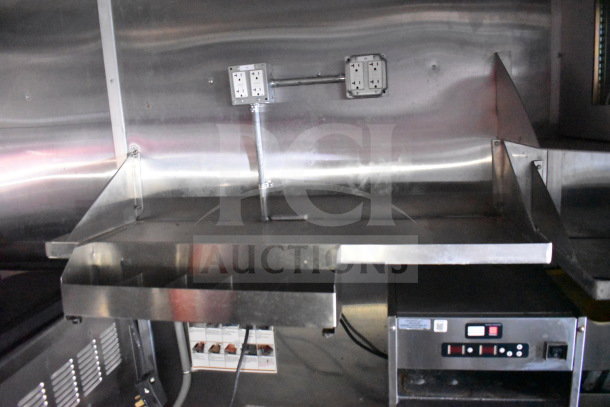 Titanium Cargo Trailers 8.5'x28' food trailer interior with metal surfaces, electrical outlets, and equipment fittings.