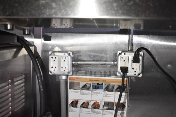 Electrical outlets and cords inside a Wendy's food trailer from Titanium Cargo Trailers. Visible chili preparation guide.