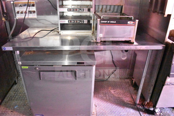 Titanium Cargo 8.5'x28' food trailer interior featuring CaptiveAire grease hood, Taylor shake machine, and Henny Penny fryer.