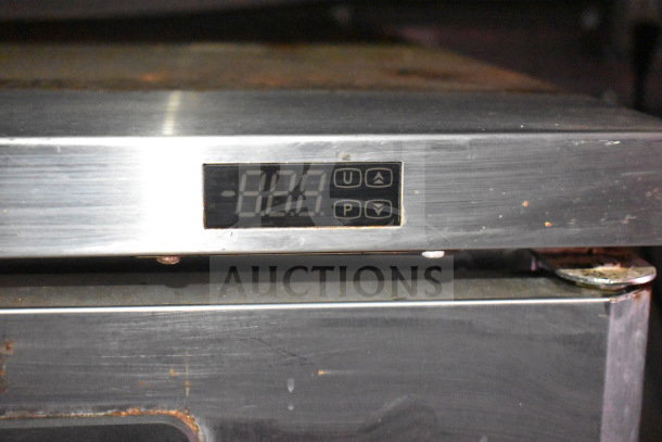 Close-up of a digital control panel on kitchen equipment with a display reading "-188." Stainless steel surface, slight wear visible.