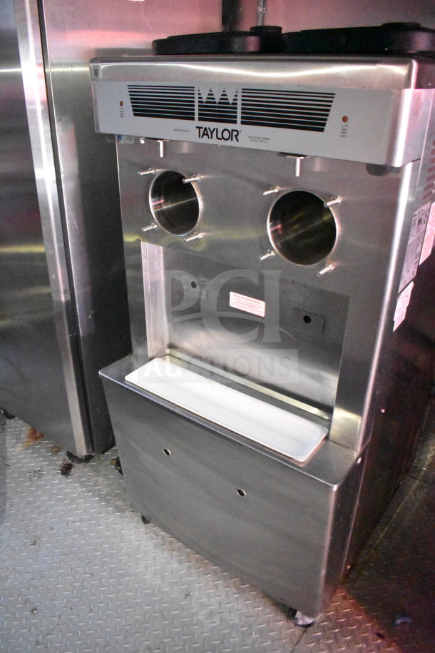 Taylor Frozen Shake Machine inside Titanium Cargo Trailer, featuring two dispensing nozzles, in excellent condition.