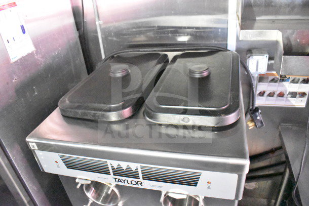 Taylor Frozen Shake Machine inside Titanium Cargo Trailers 8.5'x28' Wendy's Food Trailer. Features include CaptiveAire grease hood, Henny Penny fryer, and refrigeration suite.