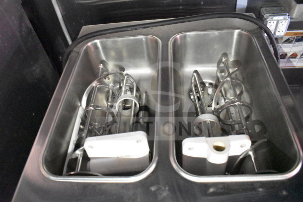 Alt Text: Stainless steel compartments in a Titanium Cargo Trailers Wendy's food trailer, housing mixer components.