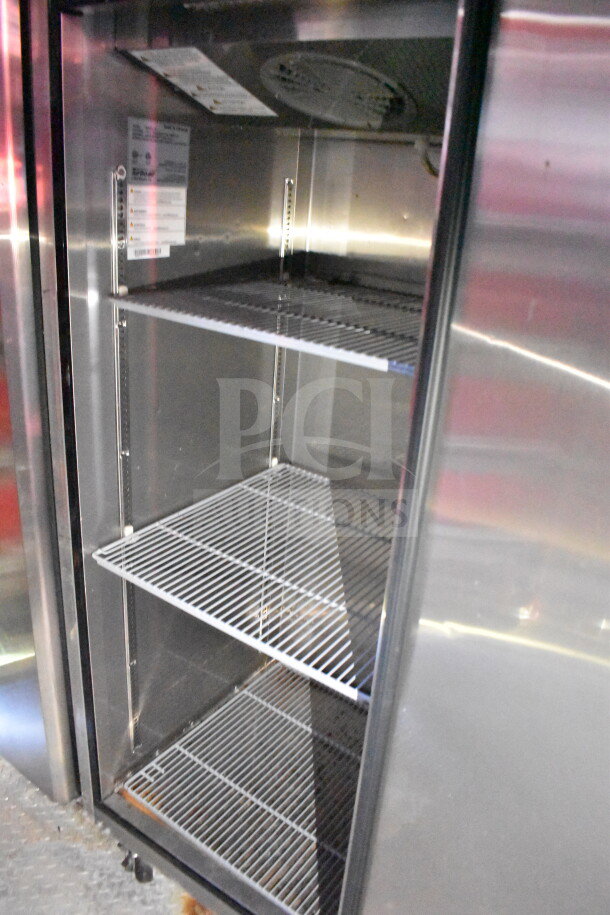 Interior of a refrigeration unit in Titanium Cargo Trailers 8.5'x28' food trailer, featuring metal wire shelves.