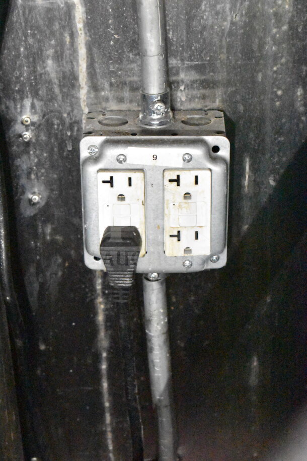 Electrical outlet inside a Titanium Cargo Trailers 8.5'x28' food trailer, with a visible plug and conduit, labeled "9".