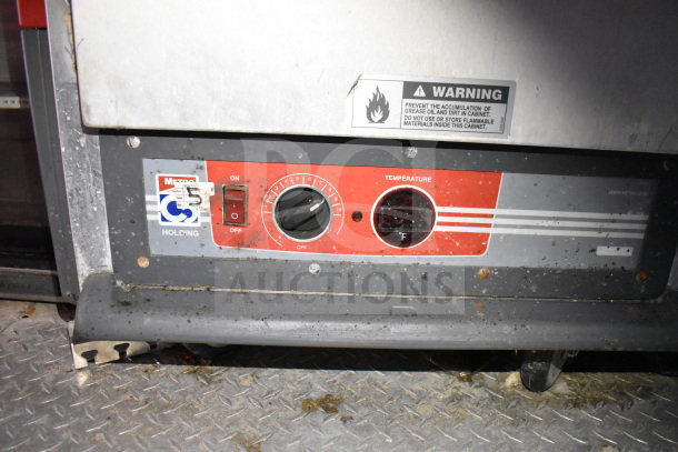 Titanium Cargo Trailer food equipment control panel with temperature dial and warning label. Visible brand is Metro.