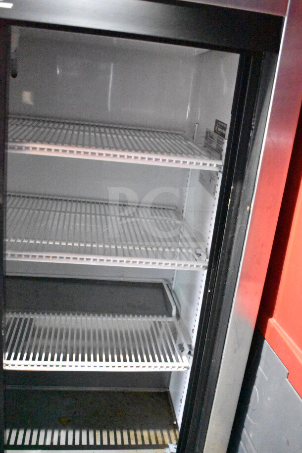 Interior view of a refrigerated compartment in a Wendy's food trailer, featuring multiple wire shelves, part of a Titanium Cargo Trailers 8.5'x28' kitchen unit.
