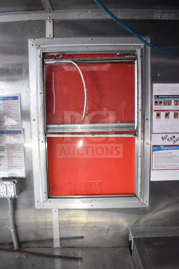 Titanium Cargo 8.5'x28' Wendy's food trailer interior, featuring a window, power outlets, and instructional posters.