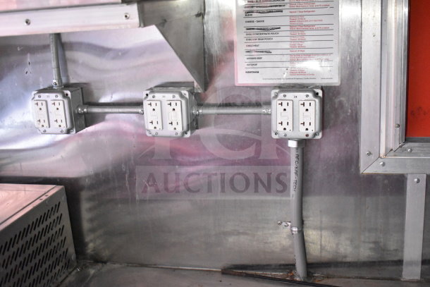 Titanium Cargo Trailers 8.5'x28' Wendy's Food Trailer interior with power outlets and mounted checklist showing refrigeration details.