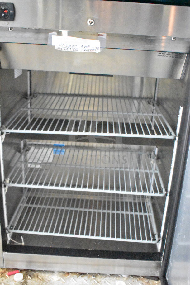 Titanium Cargo Trailers 8.5'x28' food trailer interior with stainless steel refrigeration unit, empty metal shelves, and visible controls.