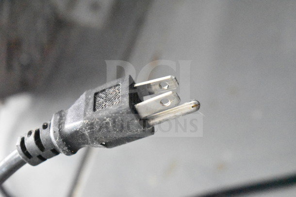 Close-up of a power plug from a 2021 Titanium Cargo Trailer with food equipment. Plug shows some wear.