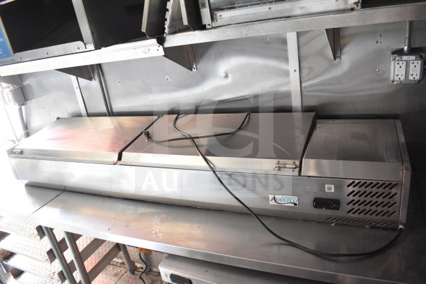 Stainless steel Avantco refrigeration unit inside 2021 Titanium Cargo Trailers food trailer, featuring a dual-lid top, standard plug, and branding label.