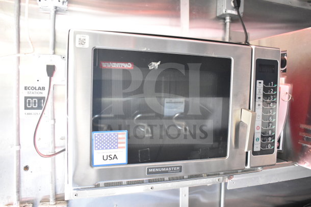 Menumaster commercial microwave in 2021 Titanium Cargo Trailer, stainless steel, Ecolab station visible, USA label attached.
