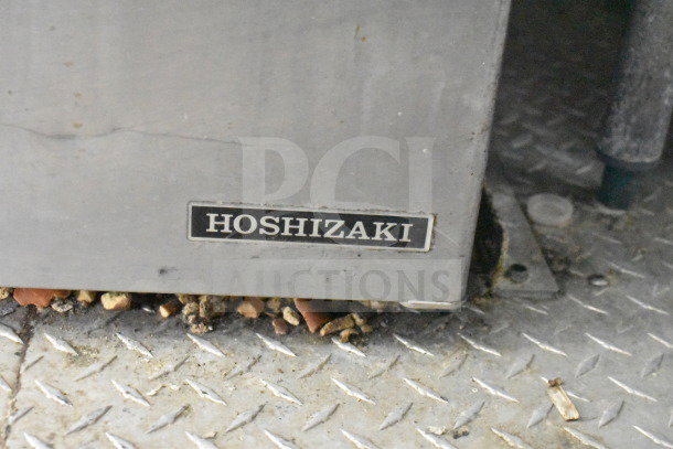 Hoshizaki label on a metallic surface, indicative of refrigeration equipment. Signs of wear and use visible.