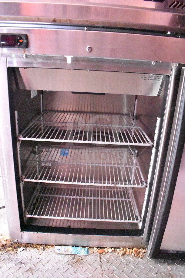 2021 Titanium Cargo Trailers 8.5'x28' food trailer fridge. Interior view with three wire shelves.