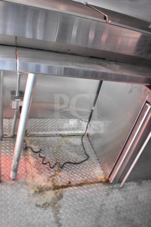 2021 Titanium Cargo 8.5'x28' food trailer interior, grease hood visible, featuring industrial metal surfaces.