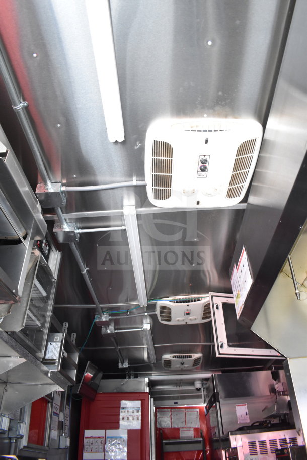 2021 Titanium Cargo Trailers 8.5'x28' food trailer interior, featuring CaptiveAire grease hood and stainless steel finish.