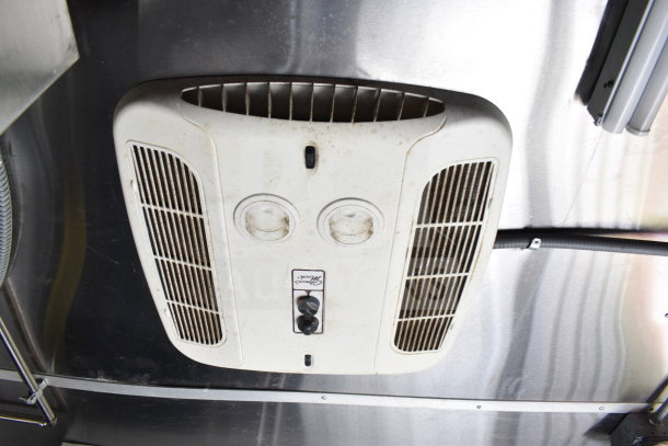 Ceiling-mounted ventilation unit in 2021 Titanium Cargo Trailer. Features dual dials and visible wear.