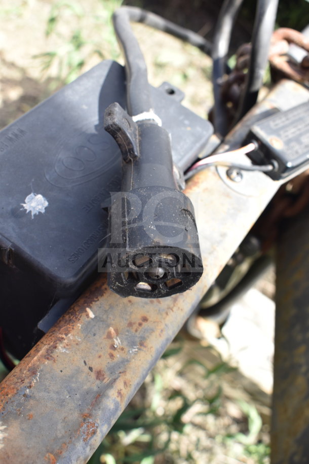 Rubber connector of 2021 Titanium Cargo Trailer, showing wear and rust on metal parts, suitable for inspection.