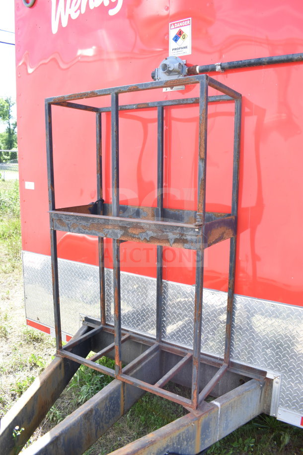2021 Titanium Cargo Wendy's food trailer exterior, visible propane warning sticker, and steel frame with rust spots.