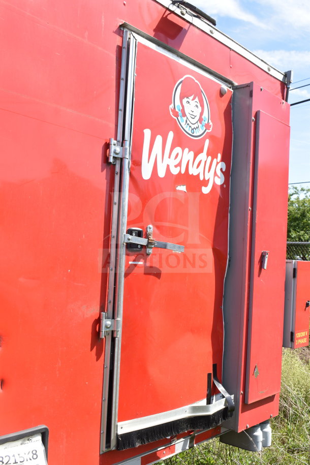 2021 Titanium Cargo Trailers 8.5'x28' Wendy's food trailer, red exterior, visible damage near door.