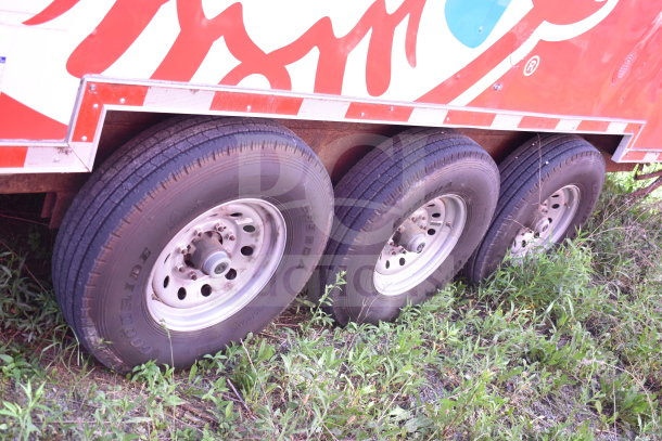 2021 Titanium Cargo Trailer 8.5'x28', triple-axle design, Wendy's branding, visible tire and wheel condition.
