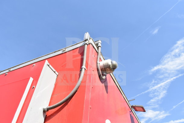 2021 Titanium Cargo Trailer 8.5'x28' in red, featuring exterior conduit and fittings, good condition.